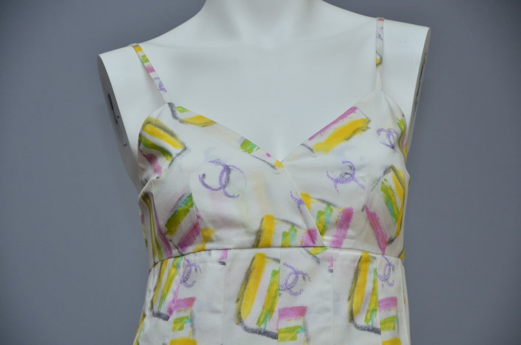 CHANEL 2004  White Multicolored Printed Sleeveless Pleated Sundress Size 40 . New with tags .Spaghetti straps,pleats going down from waist to the bottom and beautiful chanel multicolored  buttons along skirt.V neck,unlined,Zipper and buttons in the