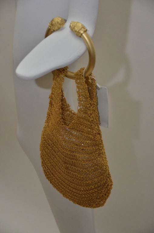One of the/or  early  first handbags made by Alexander McQueen.Made of woven gold tone metal mesh.Mini handbag,not too heavy,round handle.Brand new with tag.
Museum or collectors piece from 2006.Small opening on the top to slide your little things