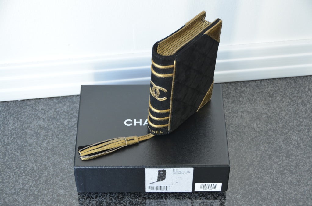 CHANEL BIBLE CLUTCH BOOK SUEDE LEATHER COLLECTOR'S ITEM LIMITED EDITION 2003
Black/gold suede quilted 'bible' clutch. Black suede and bronze metallic  leather. Front flap with hidden magnetic closure. Golden leather tassel. 
Interior flat pocket.