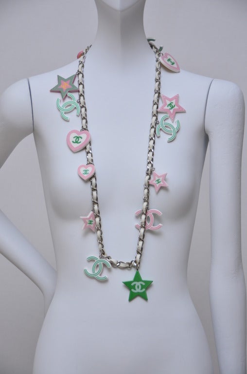 Chanel necklace or belt from 2004 collection.Large and chunky  size charms with option to be worn on  2 different sides.White leather and metal chain mix.
Total lenght :36
