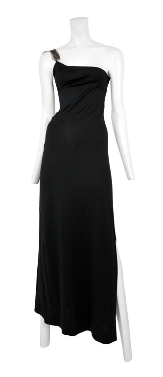 Black jersey long asymmetrical column dress with sterling metal shoulder cuff, iconic.