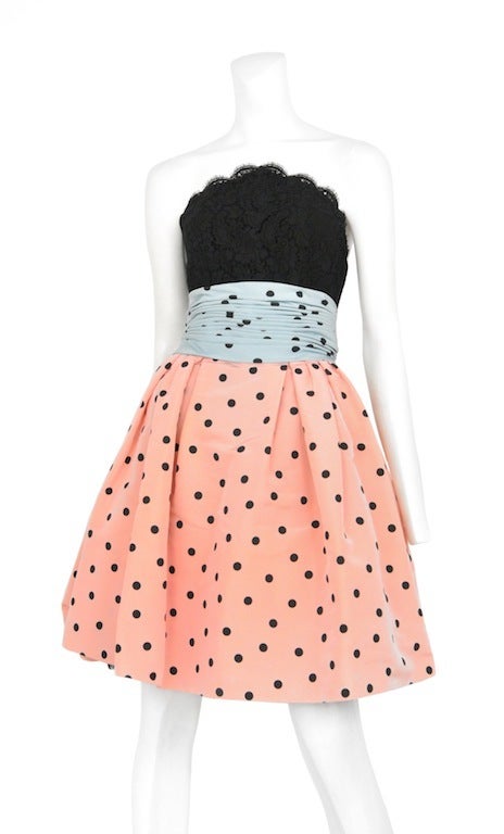 Polished cotton and lace dress with black polka dots. Zip back closure and boning in bodice.