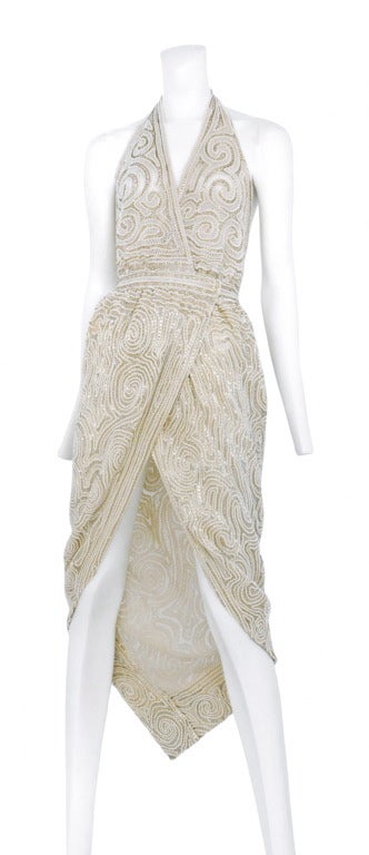 Heavily beaded white/cream wrap halter dress. Hook, eye and snap closure. Perfection.