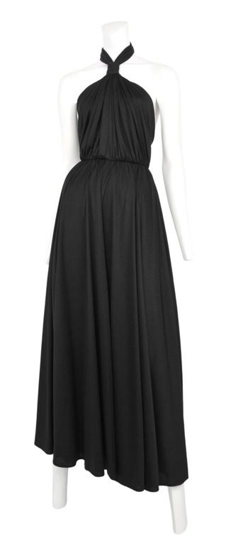 Black jersey halter gown with a gathered bodice, full flowing circle skirt, snitched neckline and low back.