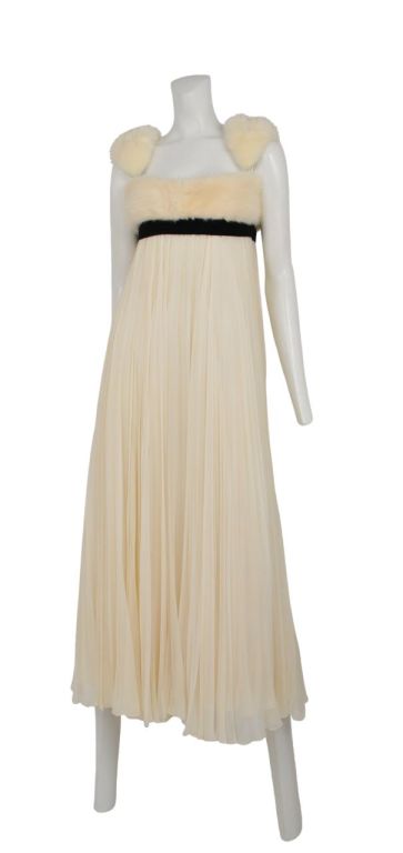 White chiffon pleated empire waist dress with white fur bodice & shoulder straps. Contrasting black ribbon just under bust line for a graphic pop.