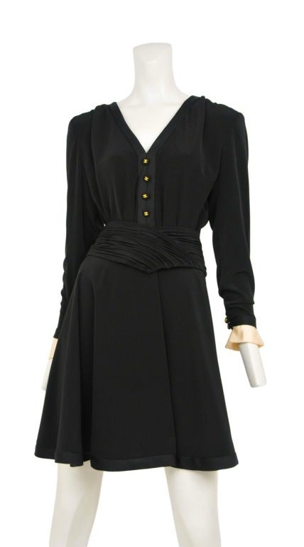 Black silk dress with flounce skirt and white satin cuffs. Ruched belt and black CC buttons at front with black satin trim at hemline, neckline & collar.