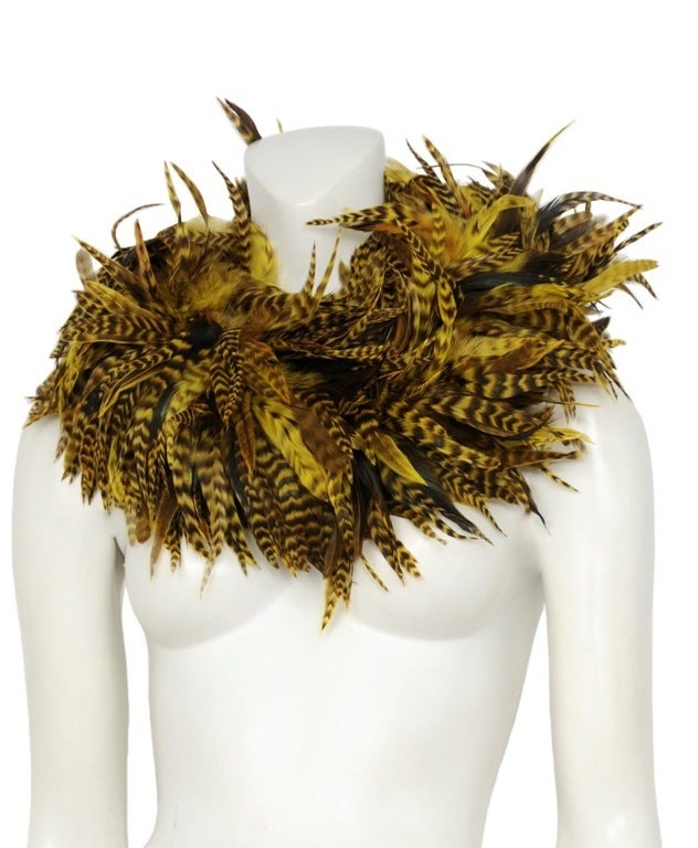 Yellow tinted rooster feather collar piece with hook and eye closure at back.