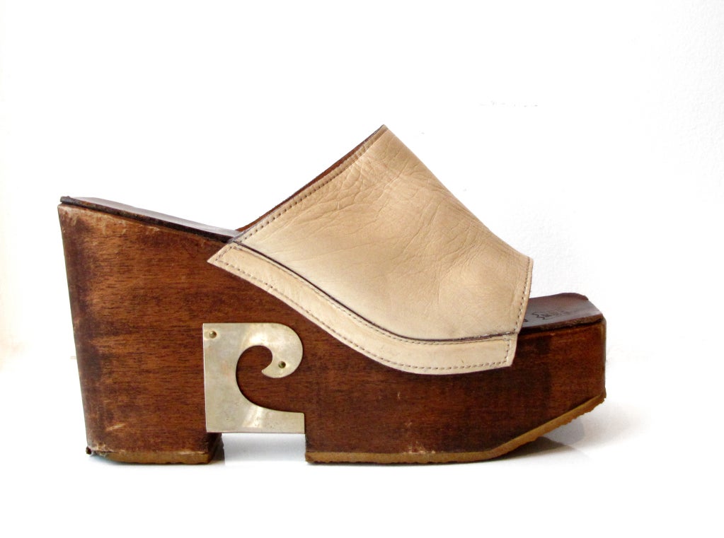 Wood platform sandals with leather upper with decorative metal Cardin logo at arch.
