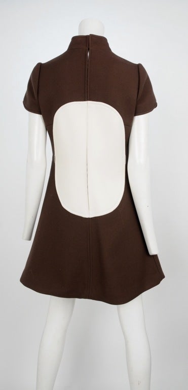 Chocolate brown mini dress with nehru collar and large cream circle center inset. Zip back closure.