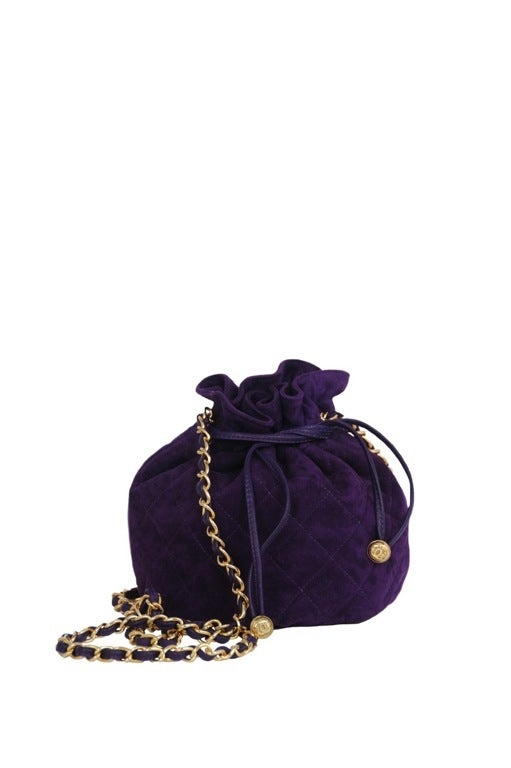 Deep purple soft suede sac bag. Drawstring leather closure with gold CC's. Chain and leather long double shoulder strap.