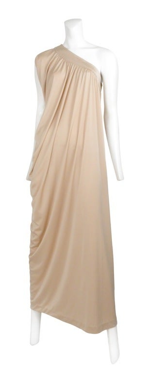 Champagne color asymmetrical jersey gown, with zip side closure and beautiful draping detail that falls to one side.