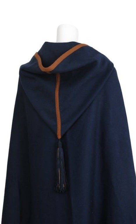 Dark navy blue cape with large hood and tassel detail. Chocolate brown trim at edges and outlines hood.