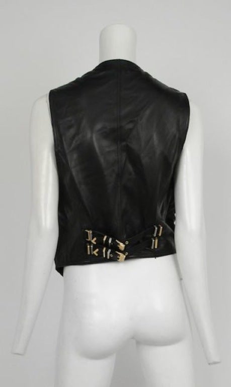 Black lambskin leather vest with Versace stud detailing on front patch pockets.