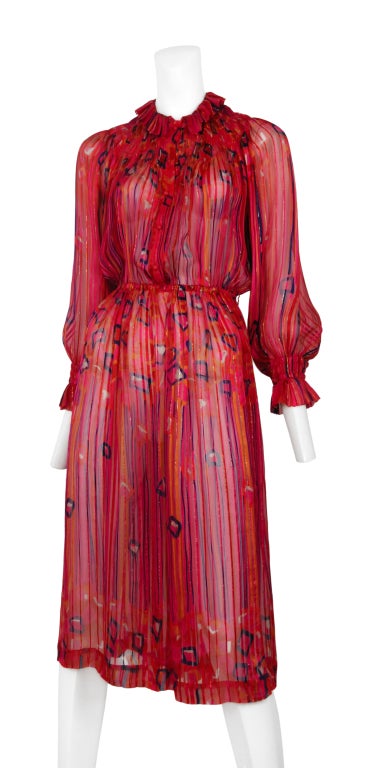 Metallic threaded fuchsia silk secretary dress by Louis Feraud. Feminine ruffle collar with button front. Slightly billowed sleeves have adorable banded cuffs. The elastic waist band could easily be worn with a simple belt.