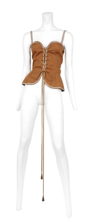 YSL corset lace up safari top with stripe trimming. Cute peplum detail cinches together with an extra long tassel cord.