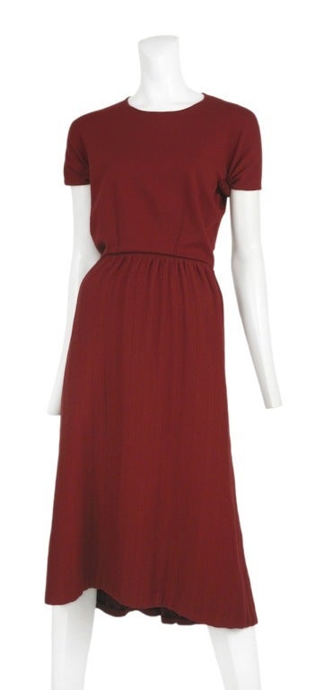 Light weight red sweater knit open back dress. Knee length full skirt, cap sleeves and crew neckline.