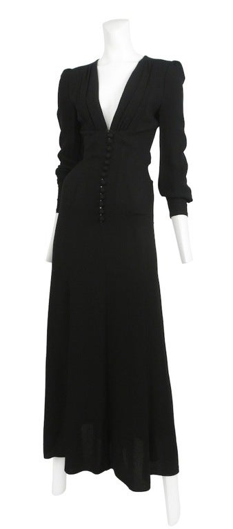 Black crepe 40's inspired bias cut dress. Deep V-neck line that falls into a row of covered button closure front.