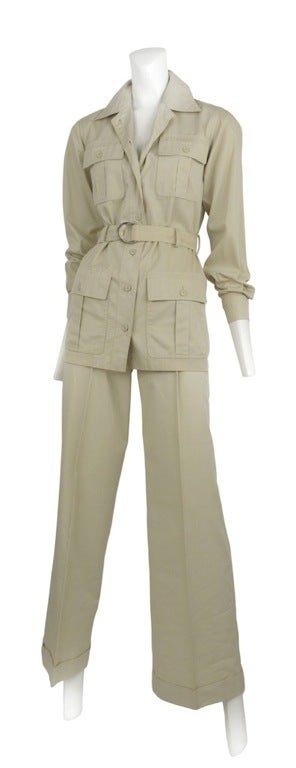 Classic khaki safari suit.  Jacket as sash belt with D ring buckle and 4 button gusseted pockets and classic pleat front trouser with slight boot cut opening.