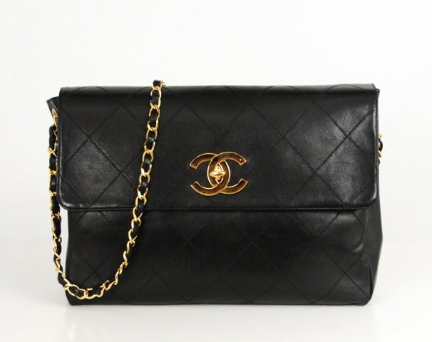 Classic Chanel flat quilted messenger bag with single leather braided cross body strap and large CC gold logo hardware. Inside zipper pouch and slip pocket.