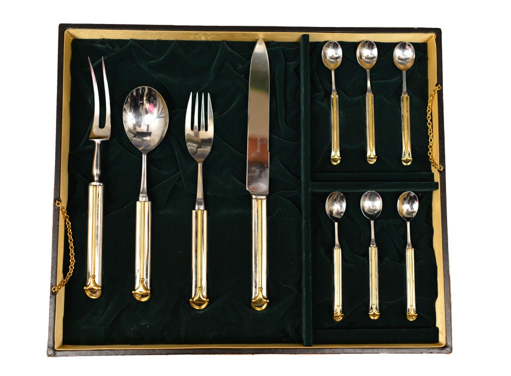 Stunning gold tone & silver 40 pc serving set complete with Gucci green velvet lined storage box. The handle of each  piece is adorn with a gold D-ring bit. All pieces shown in photos.
