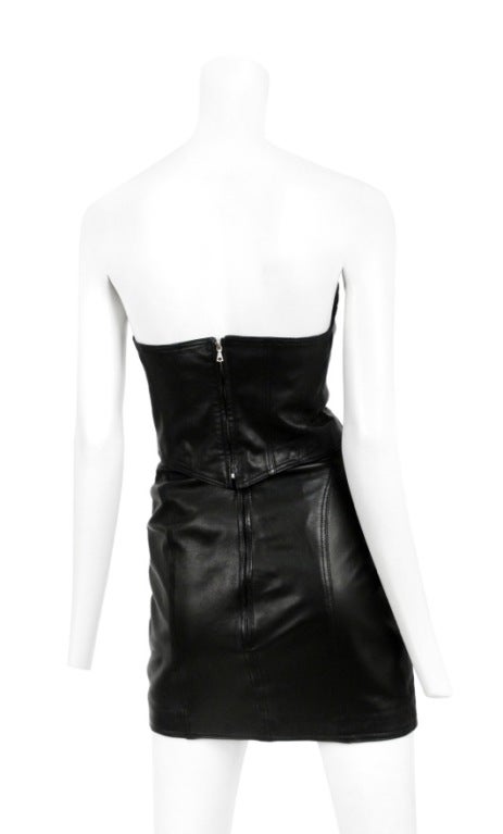 Gianni Versace lambskin leather two piece. Corseted lace up bustier top with medusa bolts.  Skirt has lace up detail to match with slight triangle cut at waist. Zips up the back.