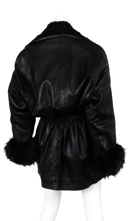 Versace double breasted leather parka with mongolian fur collar and sable cuffs. Elastic waist cinches with drawstring. Zip pockets and rhinestone button closures.
