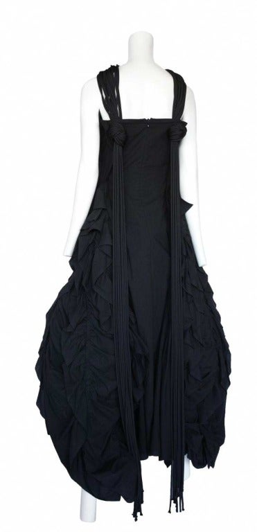 Black sleeveless ball gown with ruffle ruched hoop skirt and multi strap and fringe.