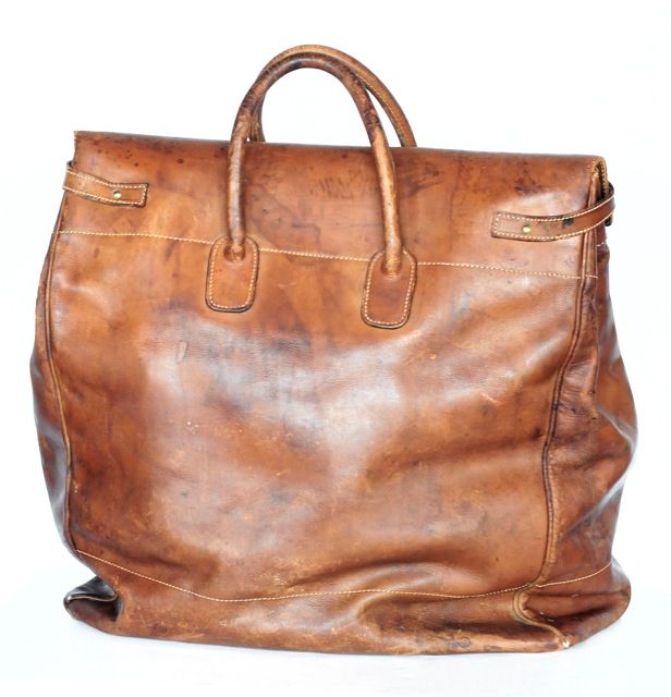1930's naturally distressed oversized Grand Voyage travel bag by Gucci.<br />
This piece is so rare and and has the most beautiful wear that could come only from loving use. It has perfectly patina brass loops that incase the strap closures with