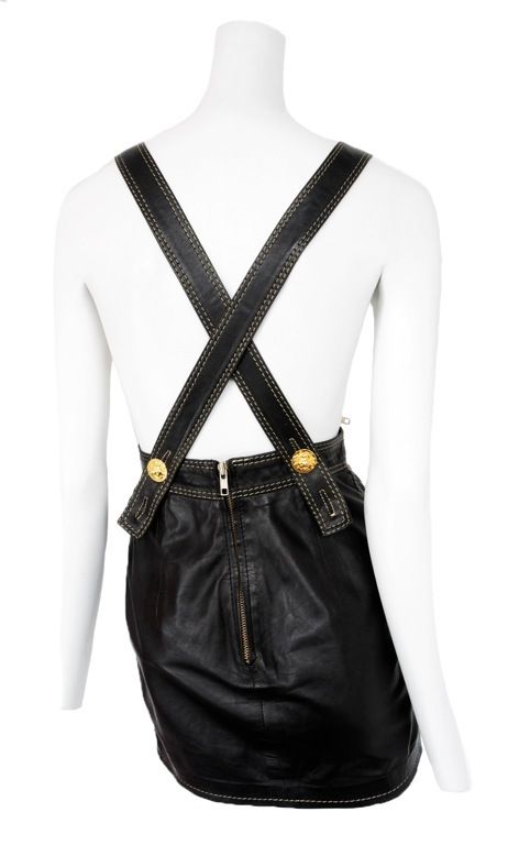 Versace leather mini skirt overalls with  white top stitch detail and medusa stud detailing.  The bib is detachable for a mini skirt look.