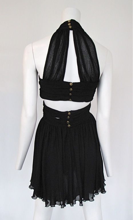 Black layered mesh mini with bandage detailing and classic Chanel gold button down the back.