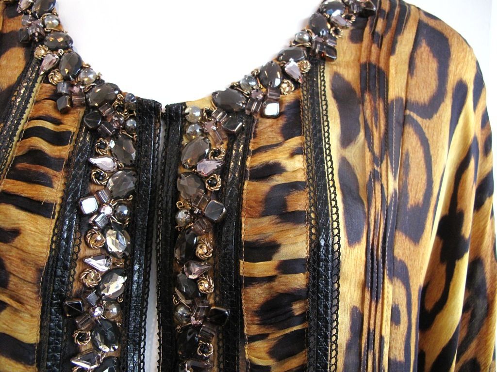 Silk satin chiffon leopard print caftan with pleating and leather detail on front panels and jewel tone crystals and beads at neckline.