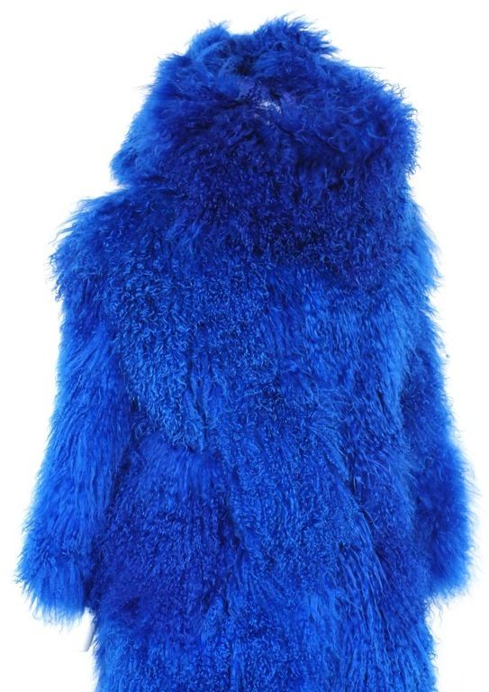 Cobalt blue mongolian fur coat with oversized scarf. This piece has a hook and eye closure and calf length. The fur is in beautiful condition with no signs of wear. <br />
A never see again piece.