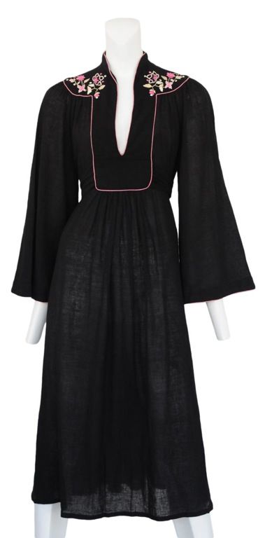 Cotton gauze caftan in dark grey with pristine embroidery at neckline and yoke. <br />
Attached self tie, nahru collar and bell sleeves. c. 1970's