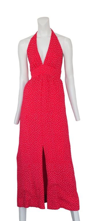 Red crepe halter dress with tiny white starburst print. Center front slit, open back and tie at neckline with zip closure at waist line.