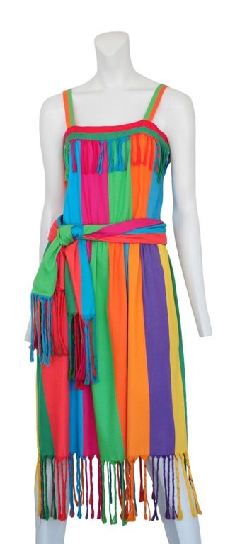 Vibrant multi colored strip sun dress.  Attached belt done in self with fantastic fringe detail that repeats at the neckline and the hem.