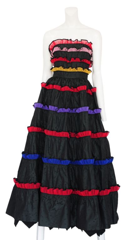 Black silk taffeta strapless gown with multi color tiered ruffles throughout and full tulle under skirt for volume.