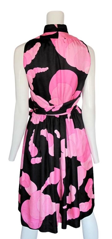 Black silk cocktail dress with vibrant pink tonal bubble print. Small slit at bodice and <br />
tie front.