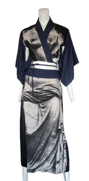 Silk 2pc. ensemble with grecian statue print on skirt and top.<br />
The top is a beautiful wrap piece with kimono inspired sleeves.