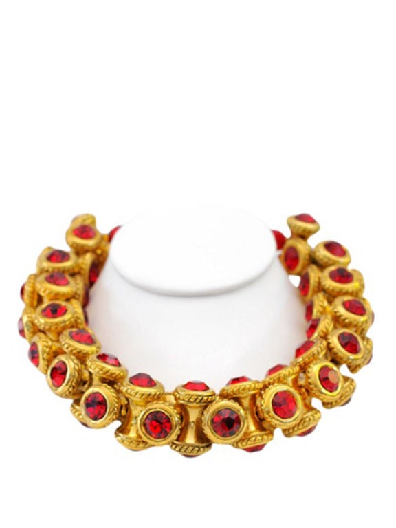 Oversized gold colored bauble necklace with red glass stones.<br />
<br />
Claire Deve is a french designer who began her eponymous line in the mid 1980's.<br />
Her design and quality is exceptional and her talents have graced many notable
