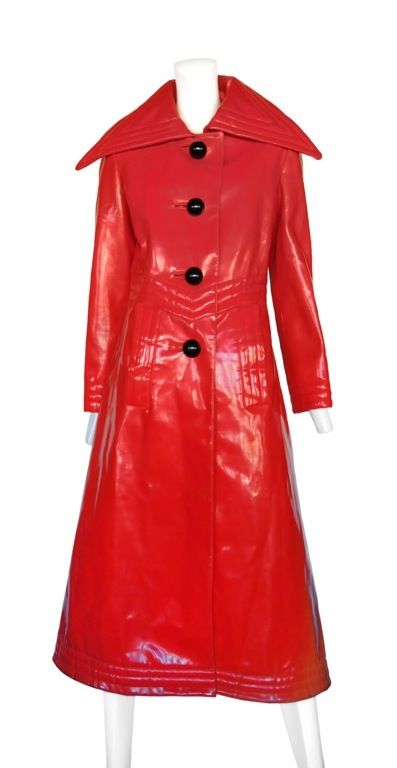 Red vinyl coat with large oversized buttons and exaggerated collar. Top stitch detail line the cuff, hem and collar