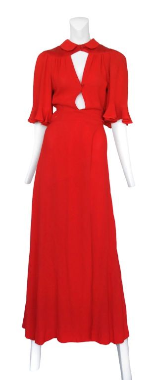 Crimson red moss crepe wrap dress with satin Peter Pan collar and Yoke. <br />
Center front double key hole detailing.