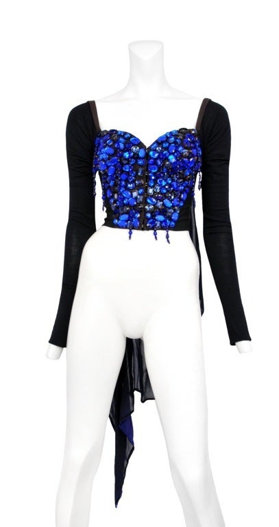 Large electric blue rhinestone jewel encrusted bustier with attached long sleeved and black chiffon train detail at back. Classic hook and eye closure down front.