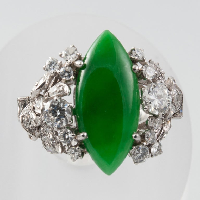 Marquise shaped natural Jade and Diamomd ring set in 18ct White Gold and Platinum.The Jade carries a certificate.. Approx 2 cts of Diamomds. Jade measures 18.5mm / 8mm and weighs 3.5cts