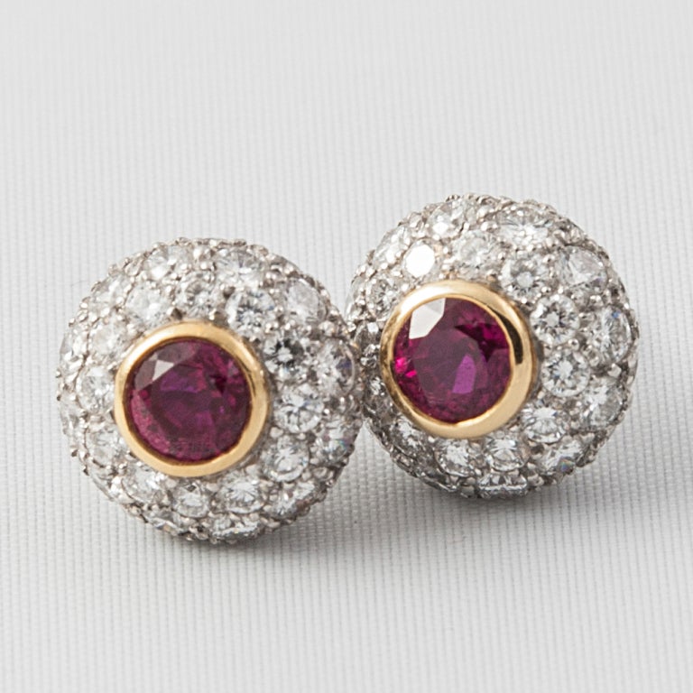 Natural Burma Rubies surrounded by three rows of Diamonds in 18ct Gold and Platinum.