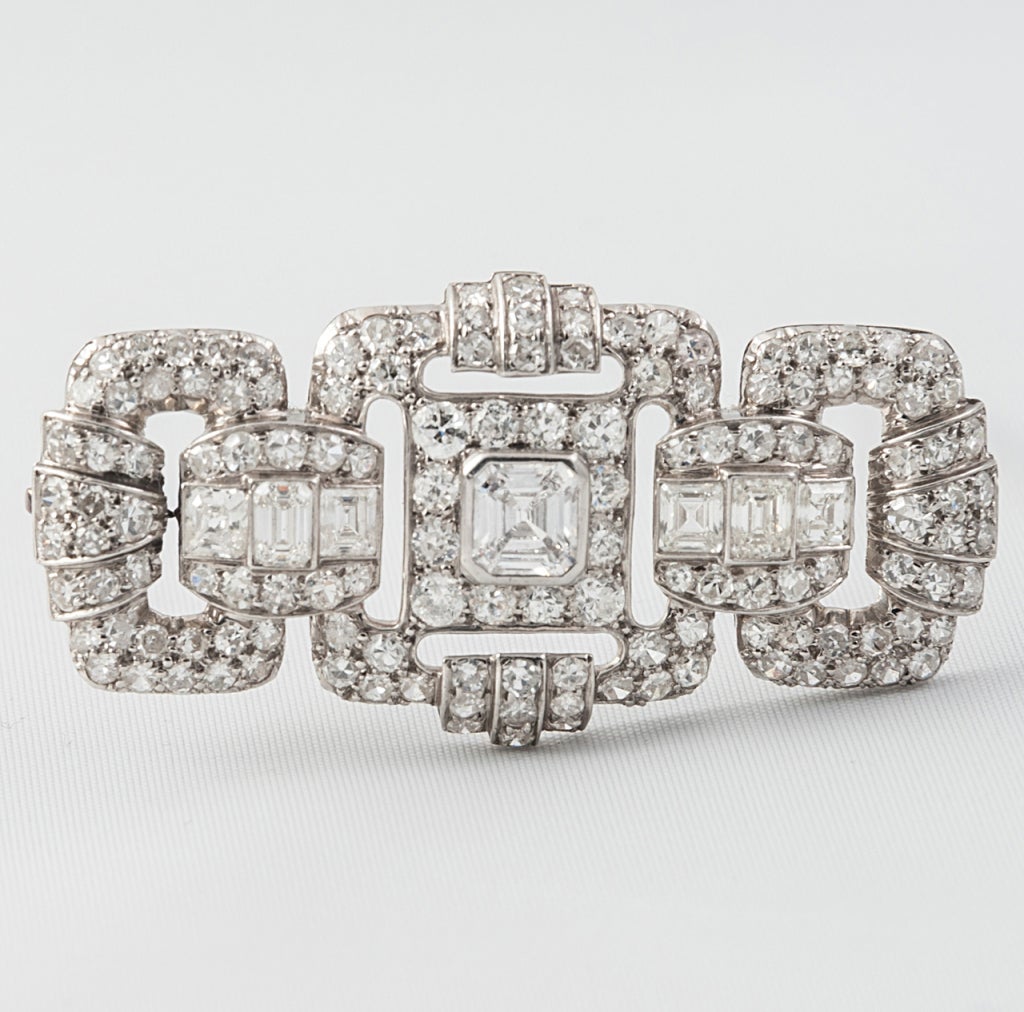 Art Deco Diamond brooch by Garrards. Set in Platinum the central Diamond is an Asher Cut approx. 1 ct surrounded by a further 4cts of diamonds approx. In original case by Garrards