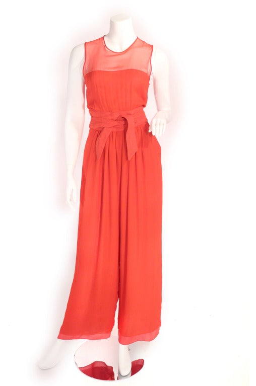 1980's red wide leg jumpsuit. This jumpsuit has it all- sheer details, pockets, wide legs, waist cinching tie, buttons up the back, and zipper. Can be worn with flats and heels. I just adore this easy flowing jumper with the knockout style and color.