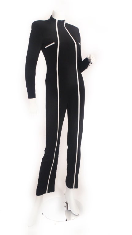 1980's Future Ozbek jumpsuit. This jumpsuit is too cool for school! Features white zippers up the front and zipper pockets and of course shoulder pads. This jumpsuit is perfect for a performer, costume, or just to simply rock!