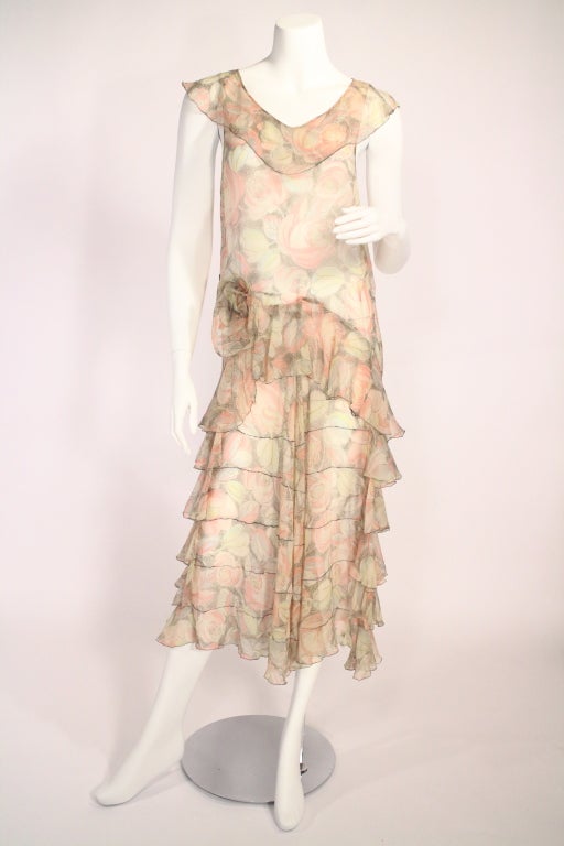 Vintage 1920's/1930's flapper floral dress. Think Gatsby! This dress is super fun and pretty. Featuring a flower detail at the hip, drop waist, gorgeous pastel coloring, and tons of flowing ruffles! This really is the quintessential summer party