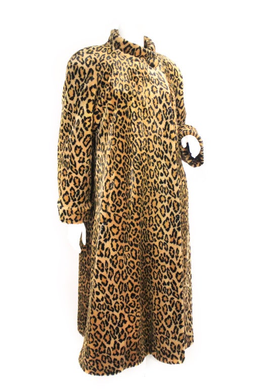 1980s Yves Saint Laurent Leopard faux fur Coat. This super fun and wearable YSL coat features shoulder pads, cuffs, and a mock collar with an oversized button closure. Fully lined. 
Sleeve length: 22