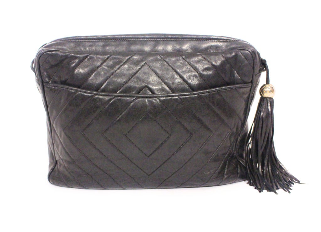 Chanel chevron quilted camera bag. Features classic tassel with CC gold tone ball, pocket in the back, multi stand leather strap. Excellent condition.
Strap- 23in